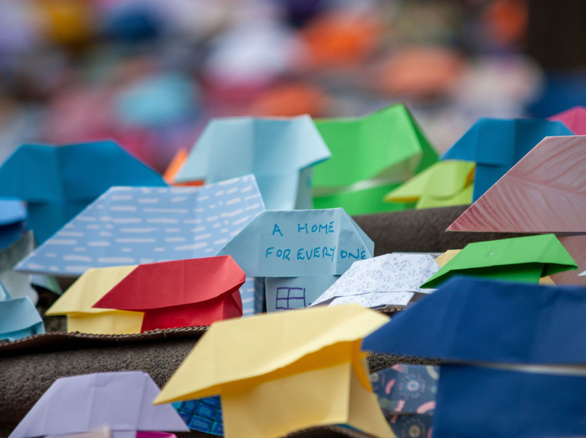 Over 6,000 origami paper houses on the steps of Victorian State Parliament in Melbourne as part of a homelessness awareness campaign, photographed by Alex Zucco.